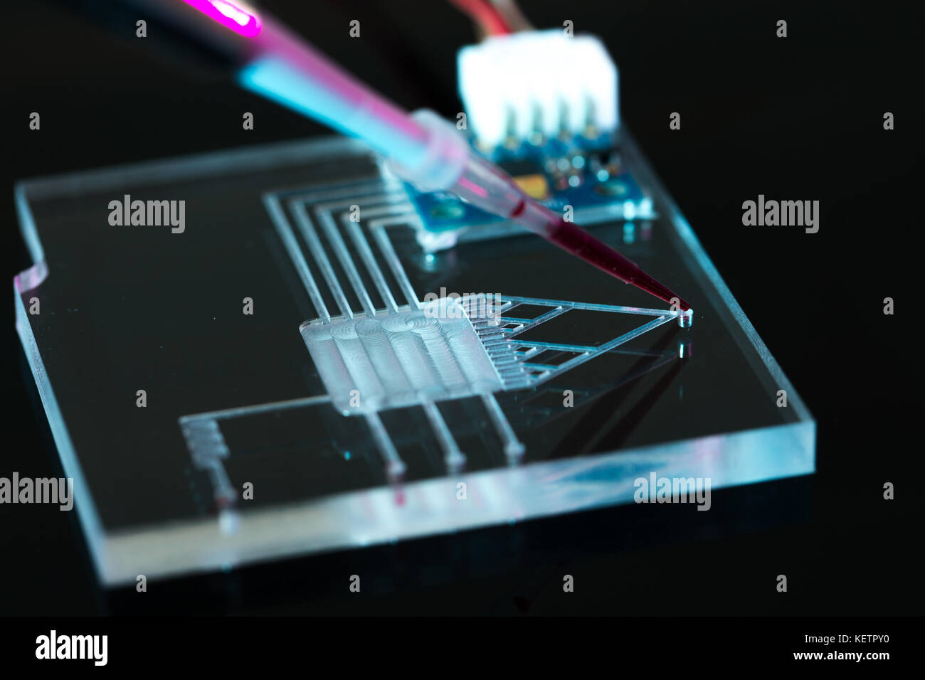A lab-on-a-chip (LOC) is integration device with several laboratory functions Stock Photo