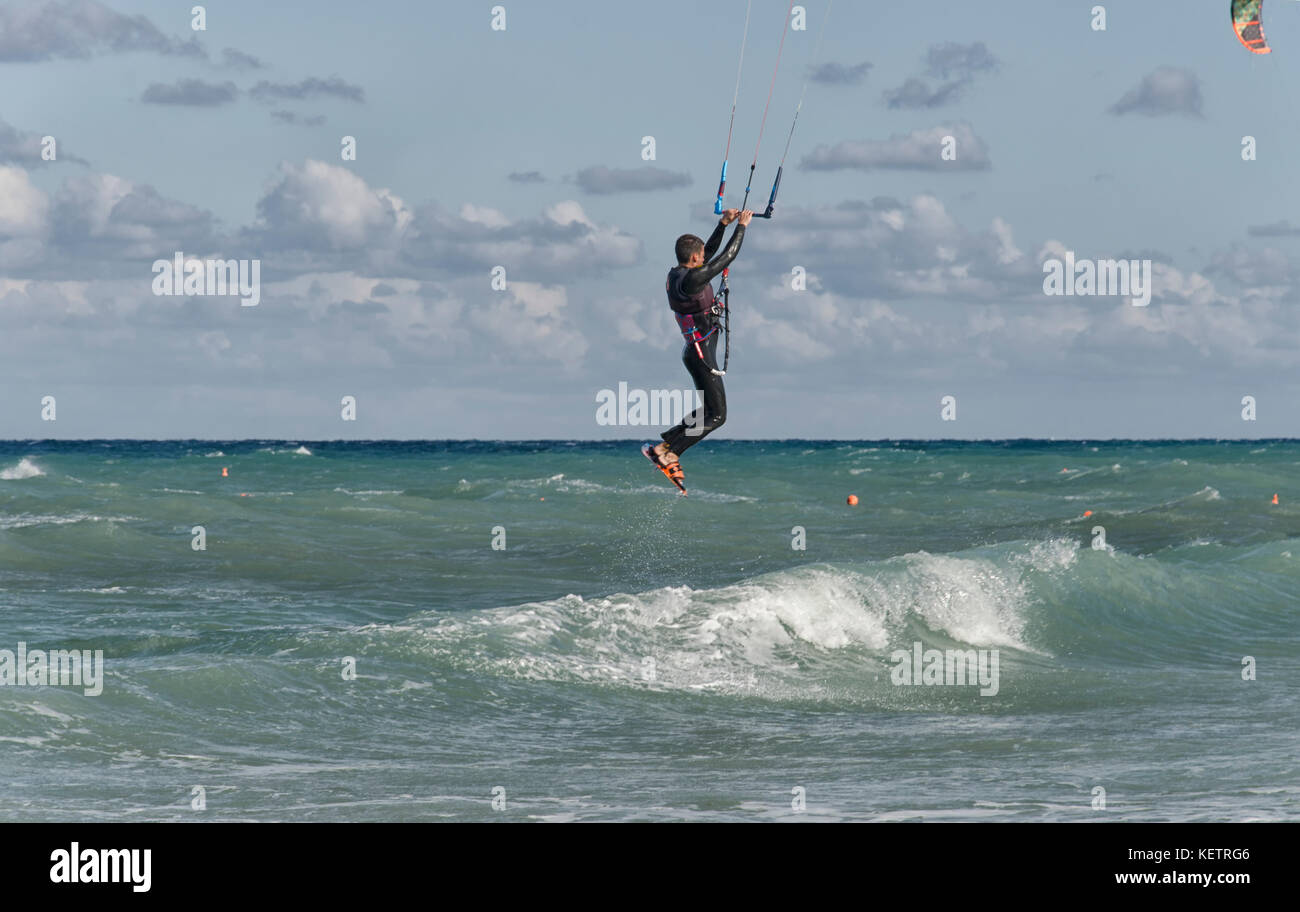 Portrait wave kitesurfer walking upwind at beach with his board and kite.  Man kite surfer walk sand ocean beach with his kite surf board Stock Photo  - Alamy