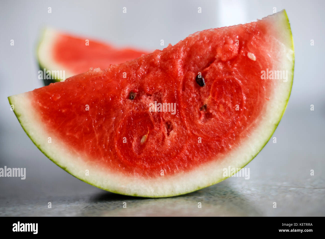 Slice of ripe watermelon on a blurred background Stock Photo
