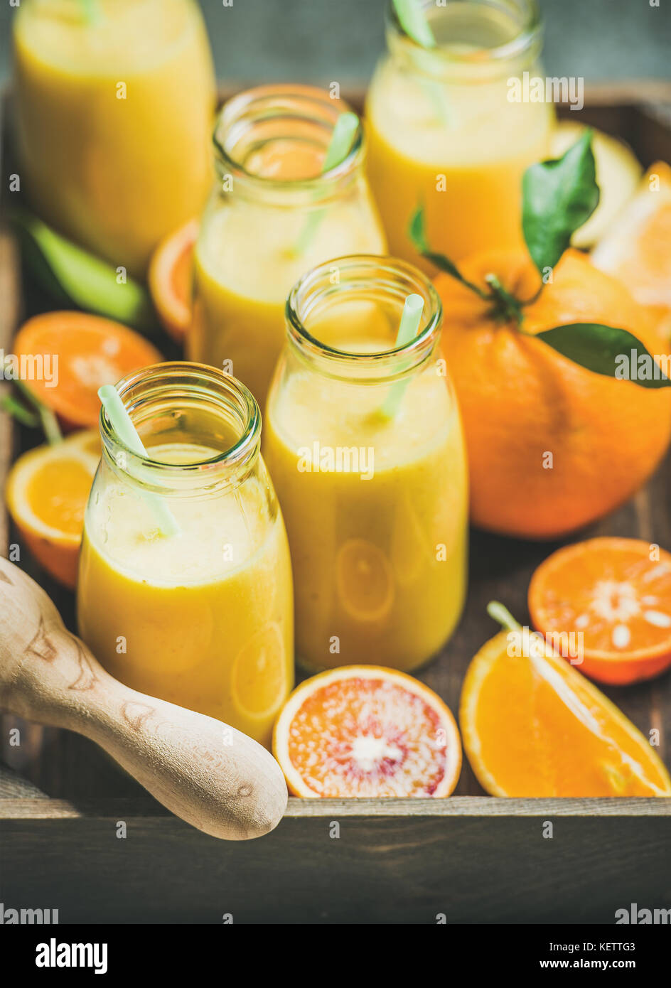 Healthy yellow smoothie in bottles in wooden box Stock Photo