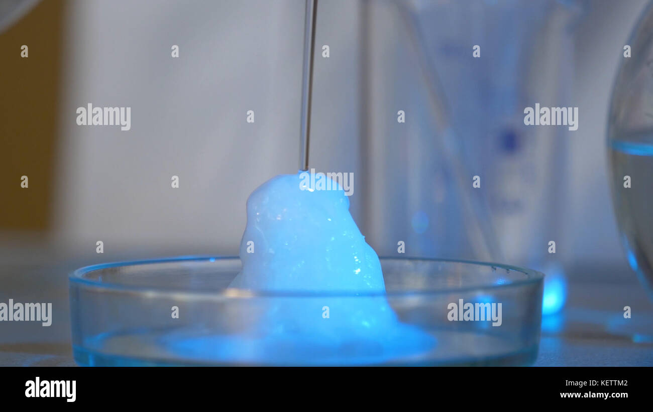 Chemical reaction in volumetric flask glass in laboratory. The chemical