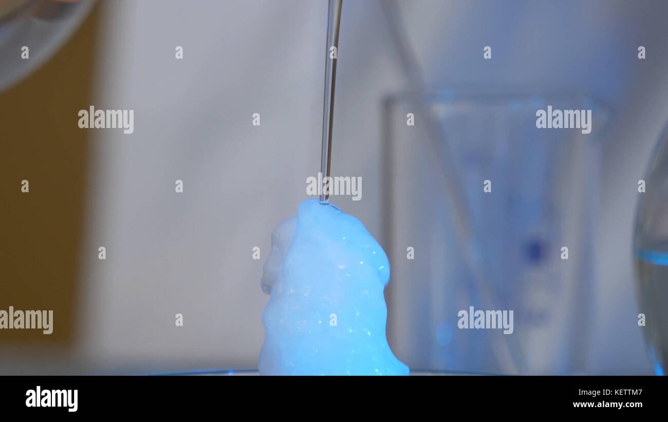 Chemical reaction in volumetric flask glass in laboratory. The chemical