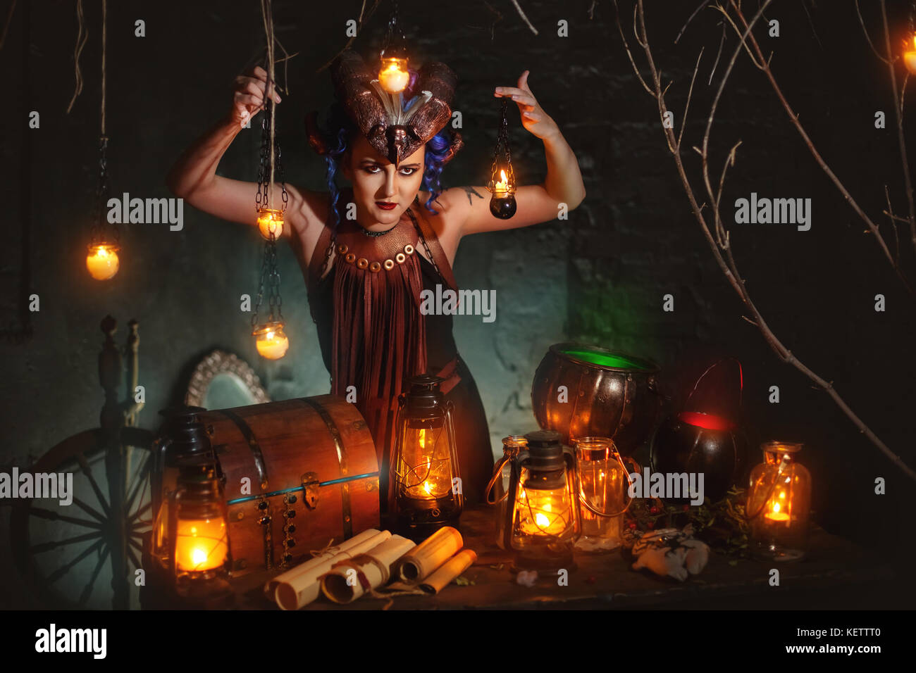 Young Witch Casts A Spell In A Dark Room Stock Photo