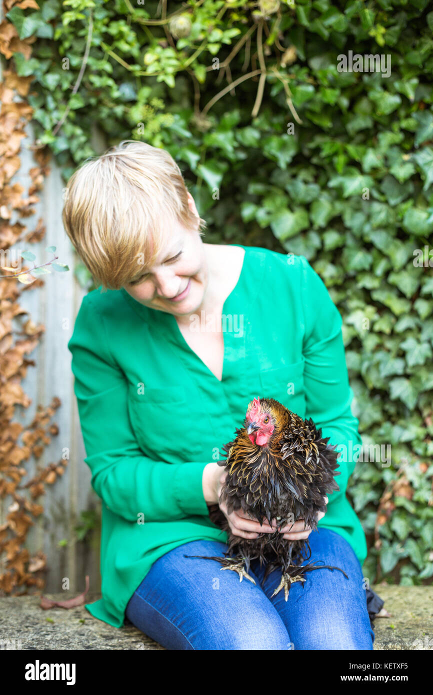 Lady with her bantam chicken pets Stock Photo