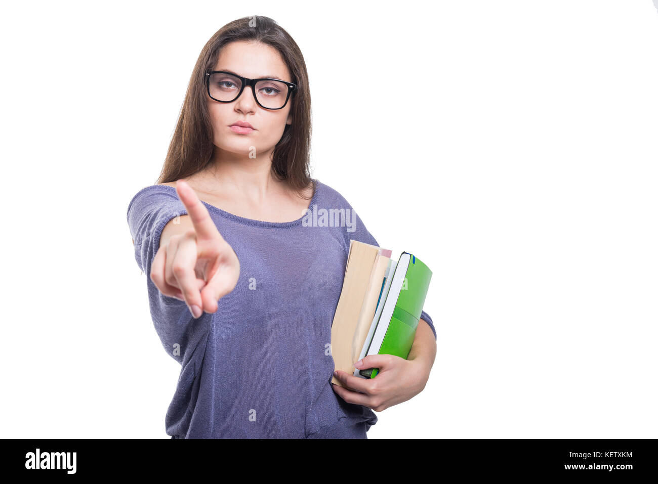 Serious young student with school books doing a refusal gesture with
