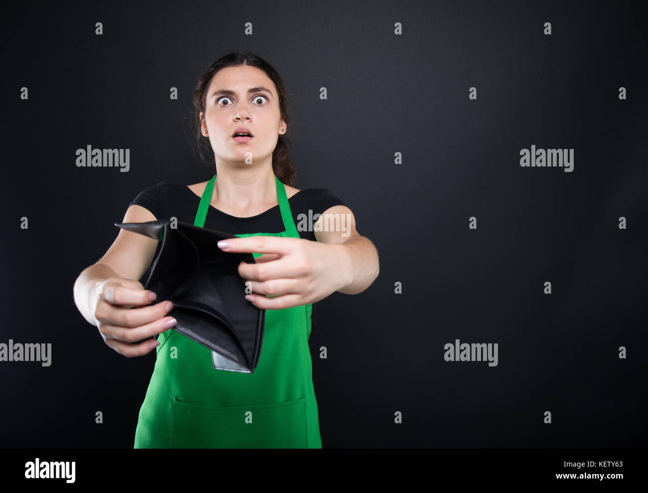 Scared Empty Wallet Shocked young woman shows her empty wallet looking stressed and ...