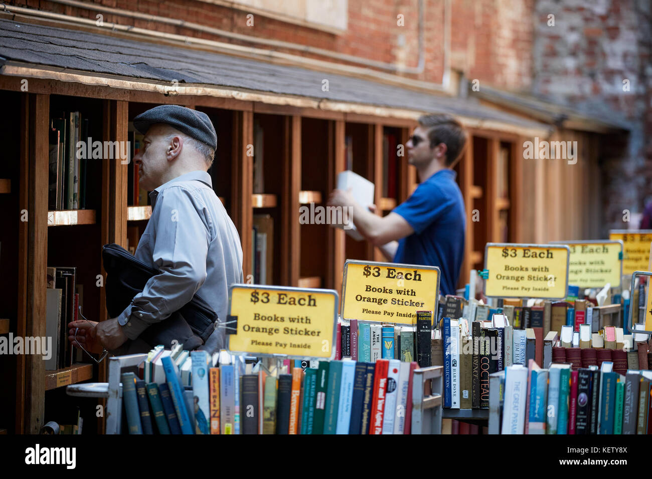 Boston Massachusetts New England North America USA , browsing secondhand books at the oldest and largest used book shop with outside sale lot Stock Photo