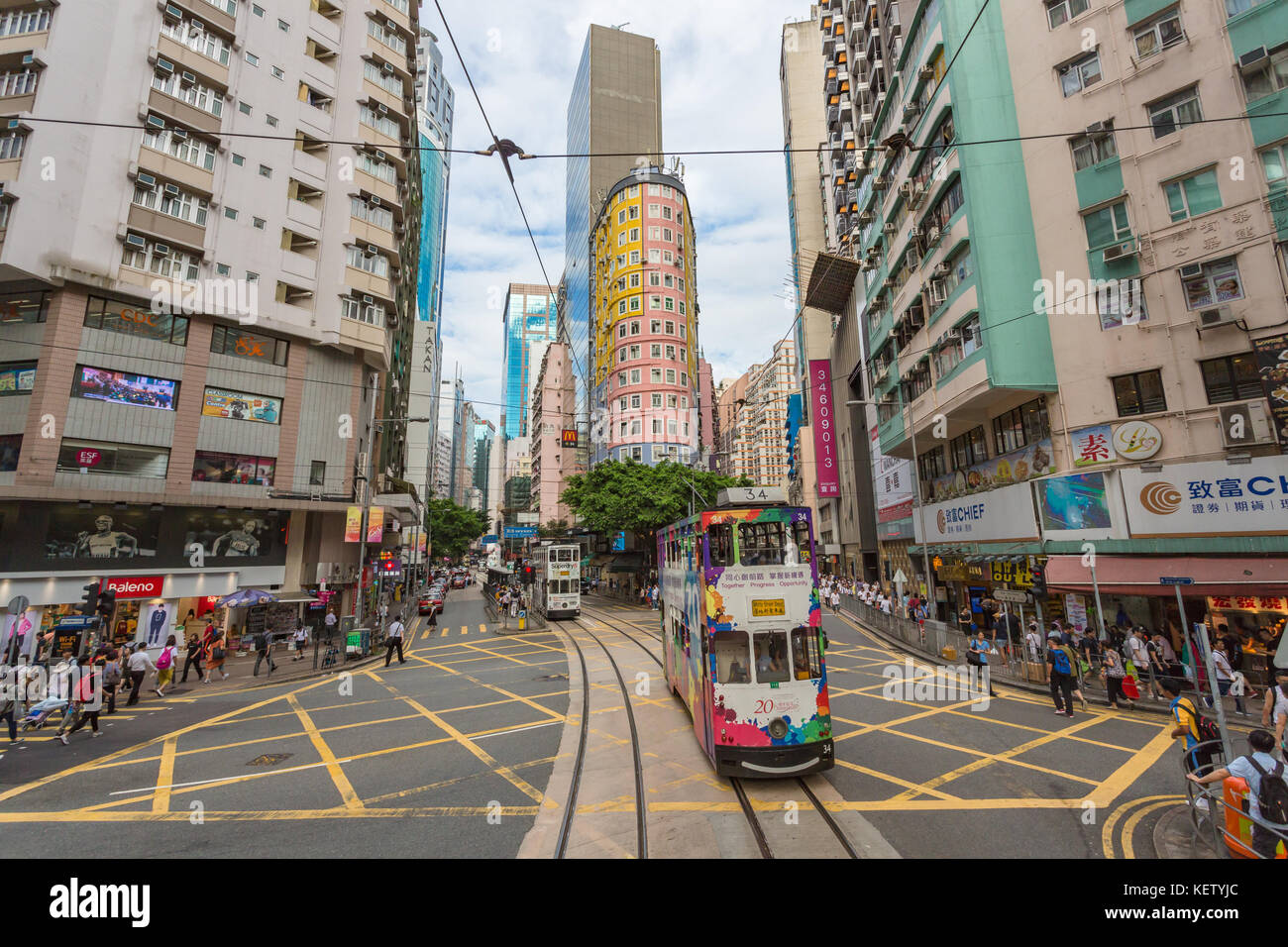 Double-decker tram on street of HK. Hong Kong Tramways is a tram system in Hong Kong, being one of the earliest forms of public transport in the metro Stock Photo