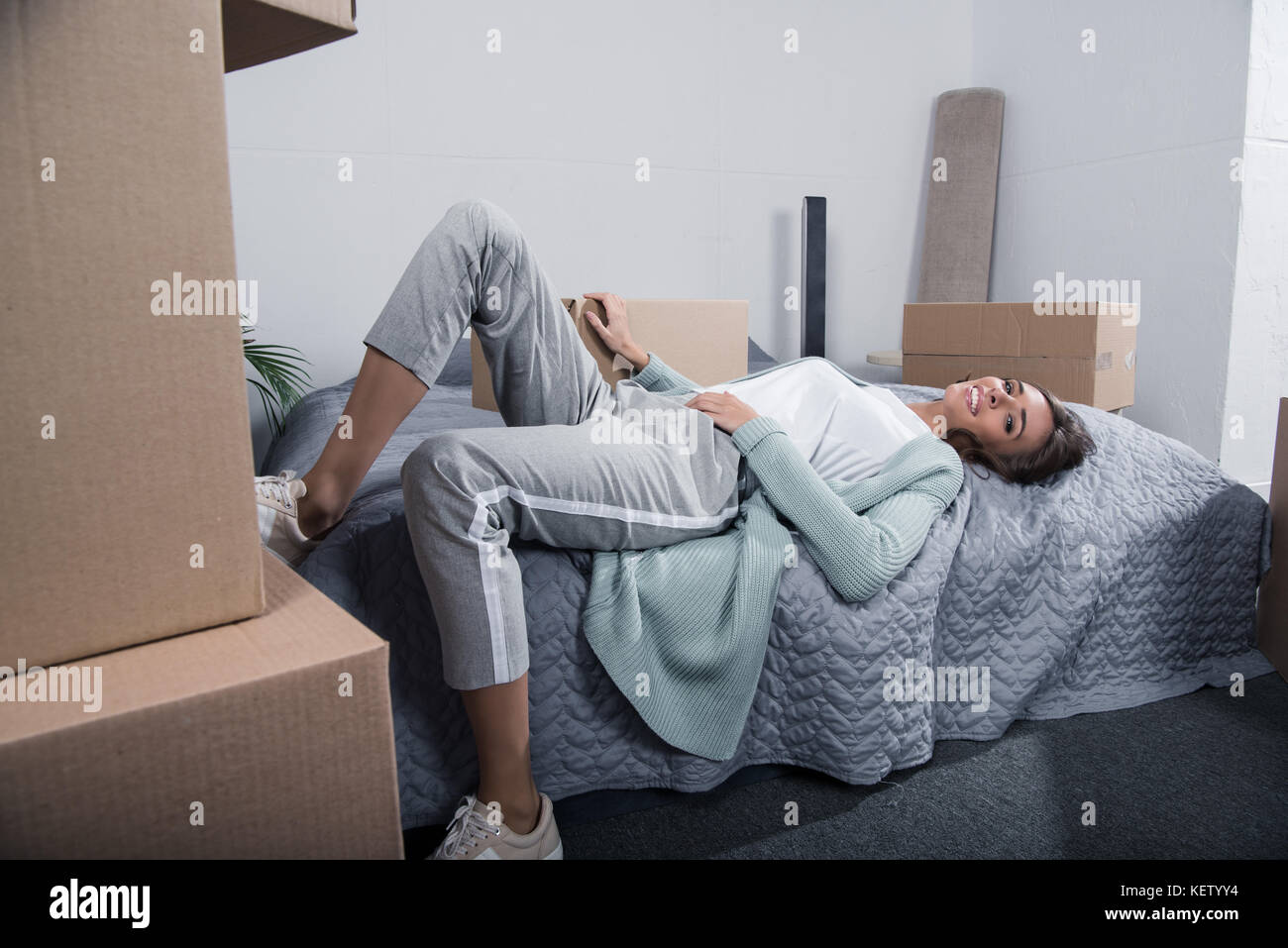 woman lying on bed at home Stock Photo