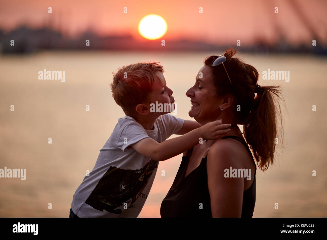 Boston Massachusetts New England North America USA, tourists pose with the skyline at sunset over the harbour Stock Photo