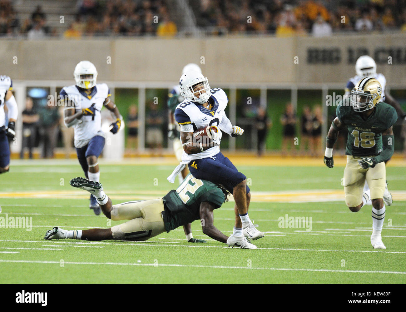Waco, Texas, USA. 21st Oct, 2017. West Virginia Mountaineers wide receiver Marcus Simms (8) spins out of tack away from Baylor Bears safety Davion Hall (12) during the NCAA Football game between the Baylor Bears and West Virginia Mountaineers at McLane Stadium in Waco, Texas. Matthew Lynch/CSM/Alamy Live News Stock Photo