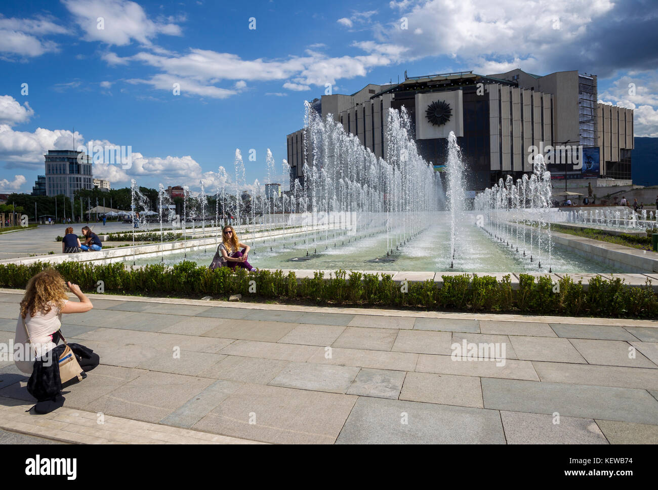 SOFIA, BULGARIA - MAY 27: Women photographed in front of National Palace of Culture, which is the largest multifunctional congress, conference, convention and exhibition centre in Southeastern Europe in Sofia, Bulgaria on May 27, 2016. Stock Photo