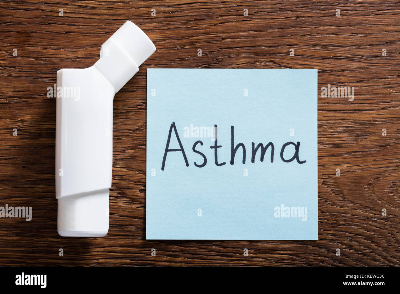 Medical Concept Of Asthma With An Inhaler On Wooden Desk Stock Photo