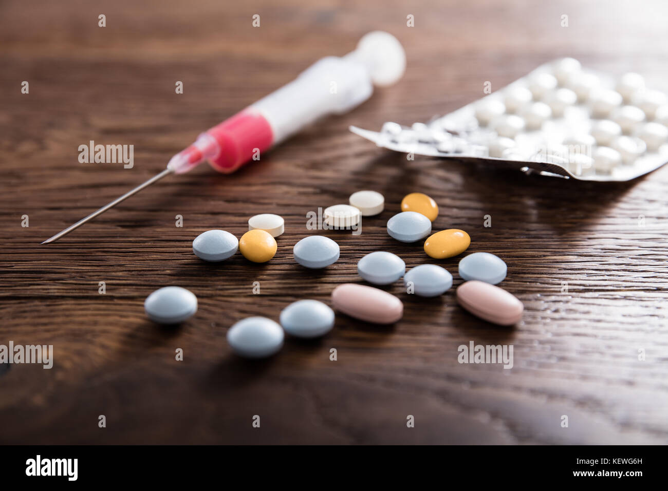 Drug Syringe A Narcotic Pills On Wooden Desk Stock Photo
