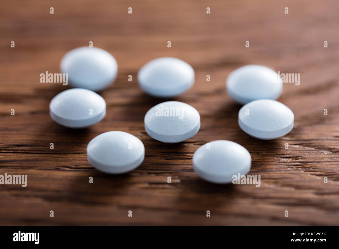 Close-up Of Ecstasy Pills On Wooden Desk Stock Photo
