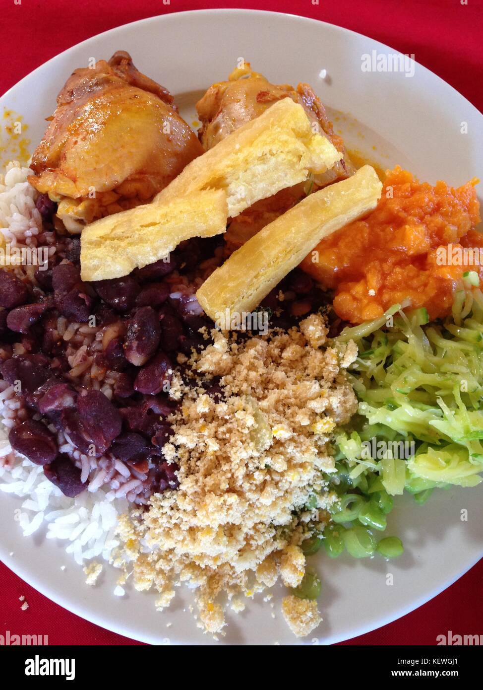 Colorful tradicional brazilian plate with rice, beans, vegetables, chicken, cassava and farofa Stock Photo