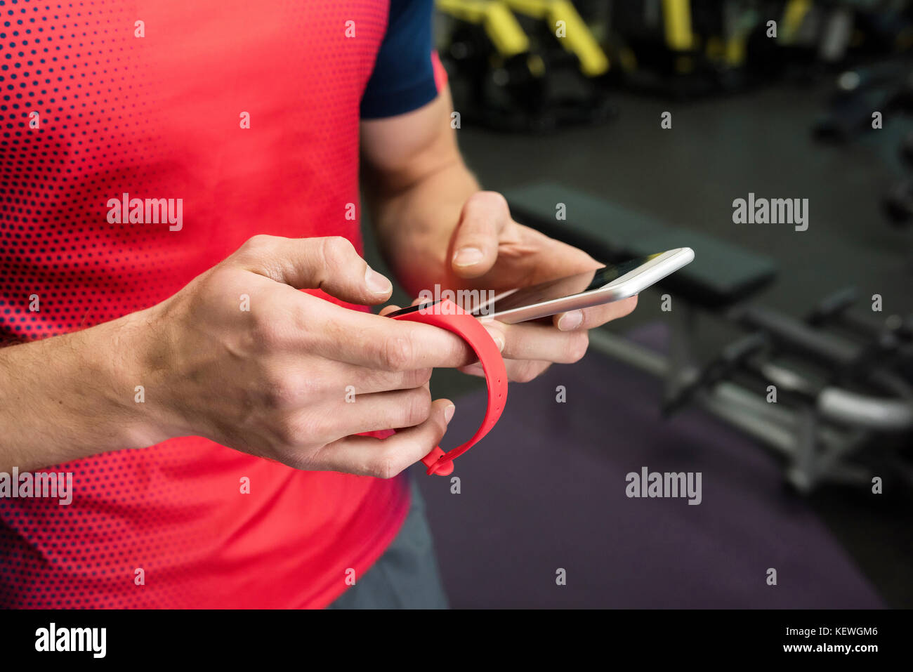 Sportsman using Fitness Device in Gym Stock Photo