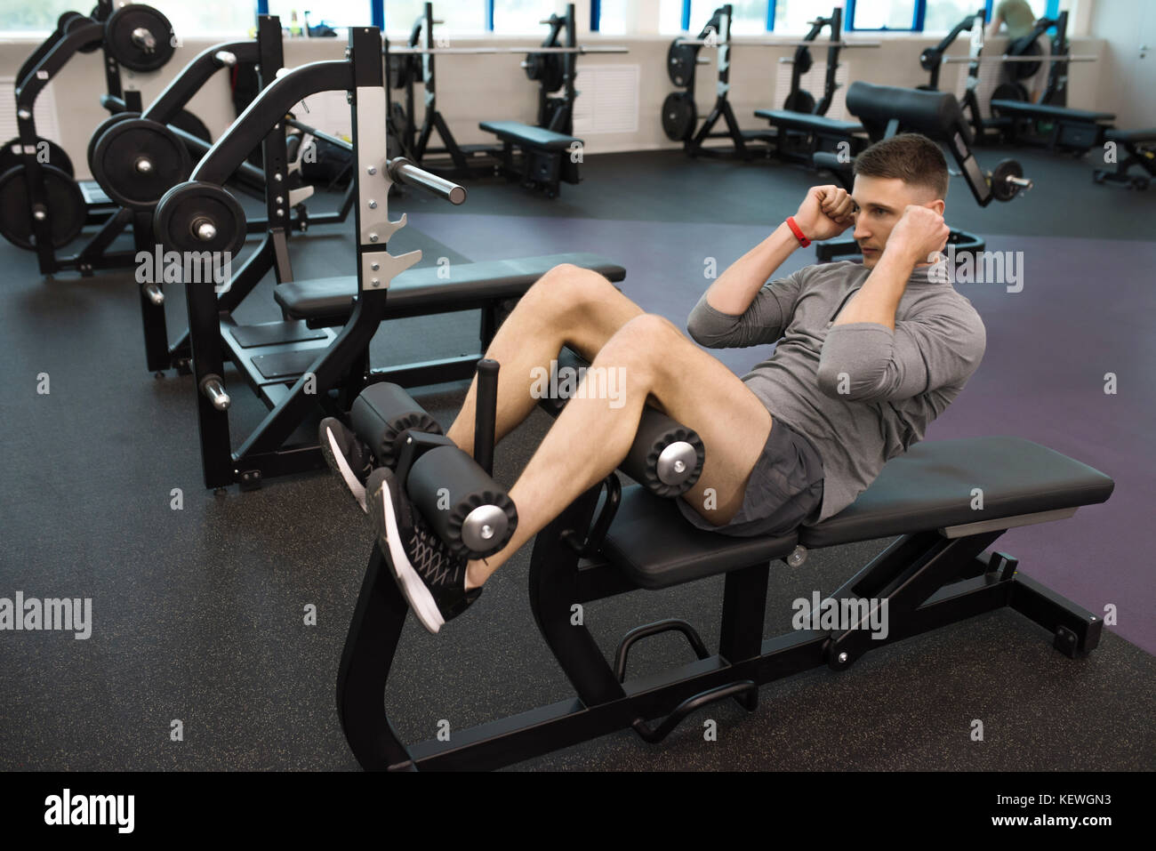 Young Man Exercising in Gym Stock Photo
