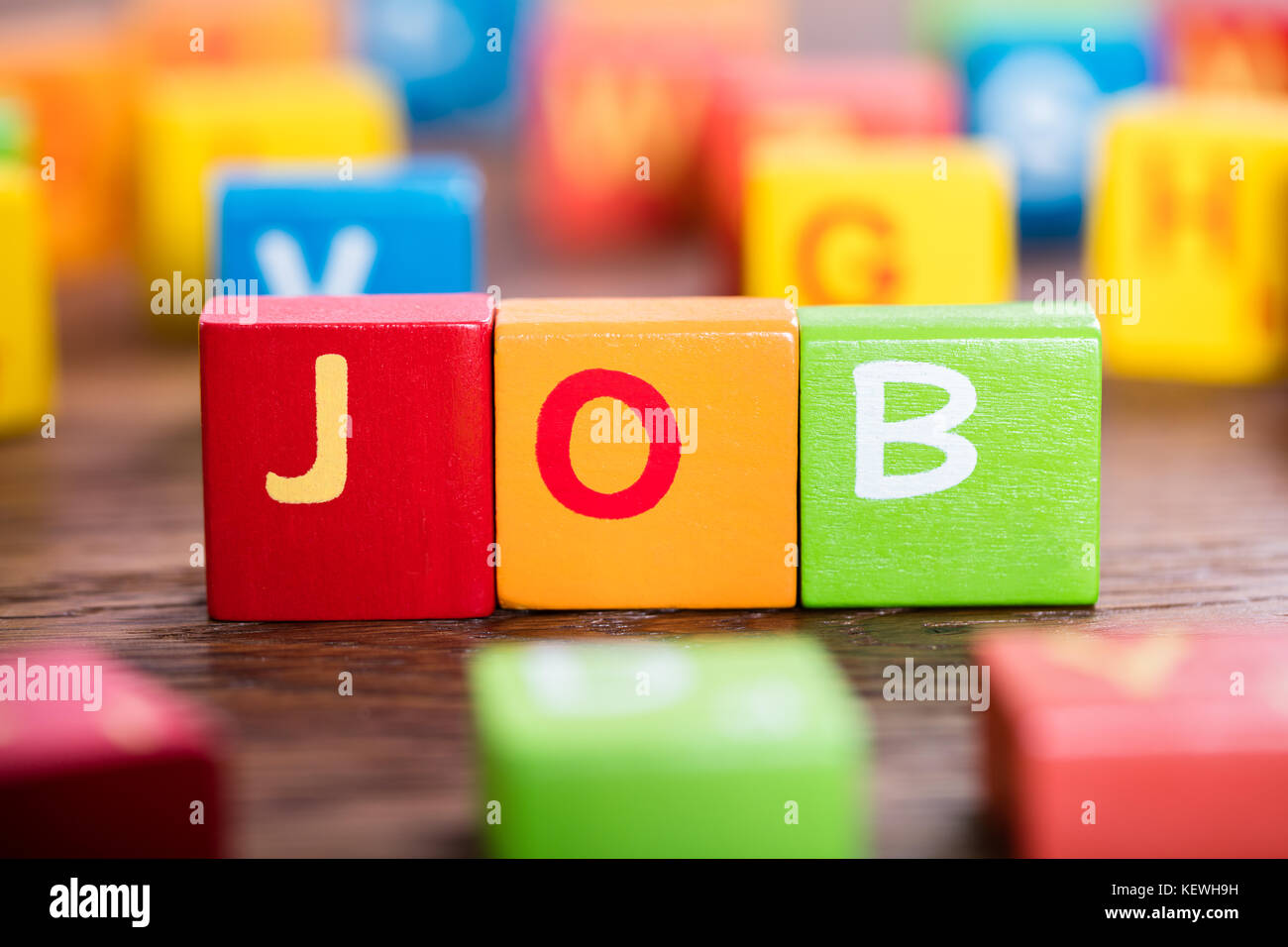 Close-up Of A Job Word On Colorful Blocks At Wooden Desk Stock Photo