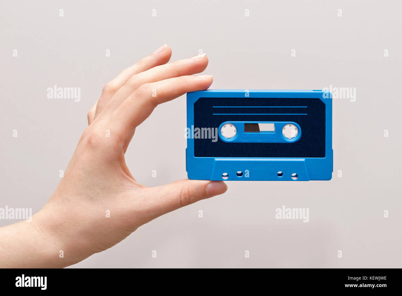 hand holding blue cassette tape Stock Photo Alamy