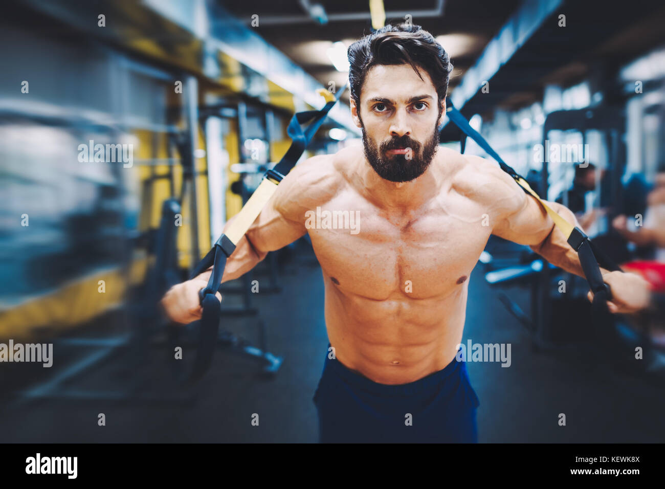 Young handsome man doing exercises in gym Stock Photo