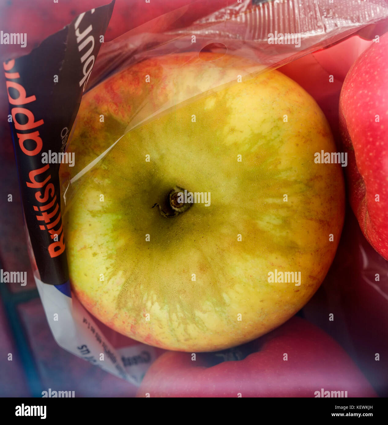 still life close-up of English apples in cellophane wrap Stock Photo