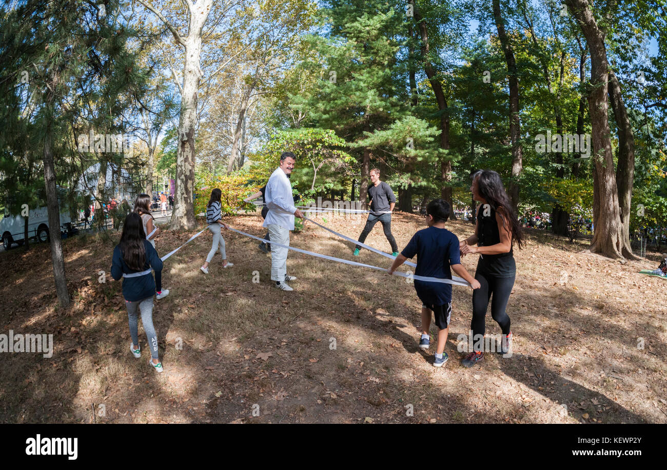 Visitors engage in 'Fine Lines: Spatial Drawing with the Body' by Cheryl-Zi Wong and Devan Harlan Simunovich at 'It's Happening!'. Reminiscent of a 1960's 'happening' the Public Art fund brought performance, sculptures and other artists to Central Park for 'It's Happening!' on Saturday, October 21, 2017. Thousands of visitors came to Central Park's East Pinetum to experience performance art, sculpture and to get their hands dirty creating their own artworks.  (© Richard B. Levine) Stock Photo