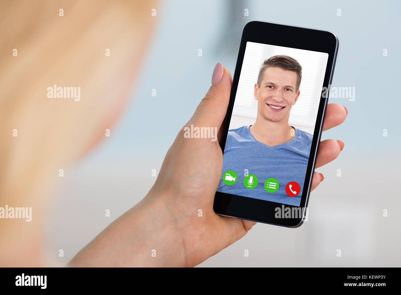 Close-up Of Woman Videoconferencing With Man On Mobilephone. Online Dating Concept Stock Photo