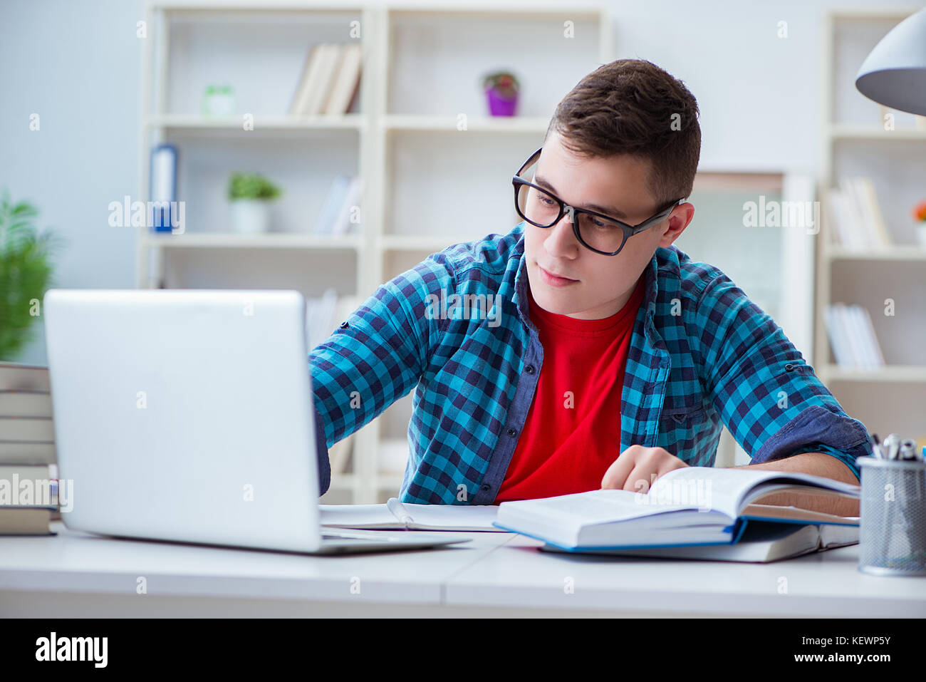 Student Preparing Young teenager preparing for exams studying at a desk indoors Stock ...