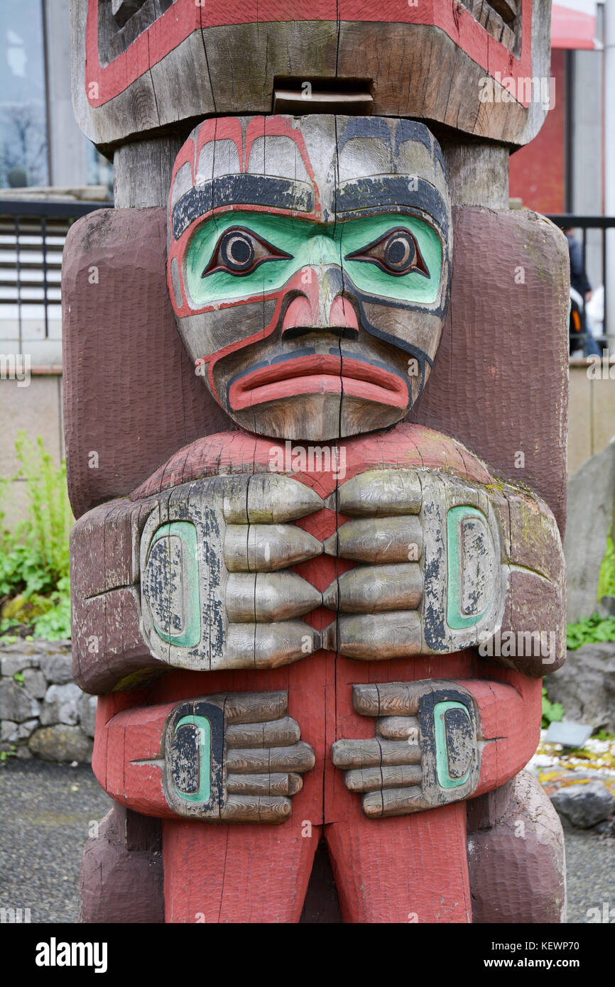 Traditional Northwest indigenous totem pole on display on the grounds of the Royal BC Museum, Victoria, British Columbia, Canada. Stock Photo