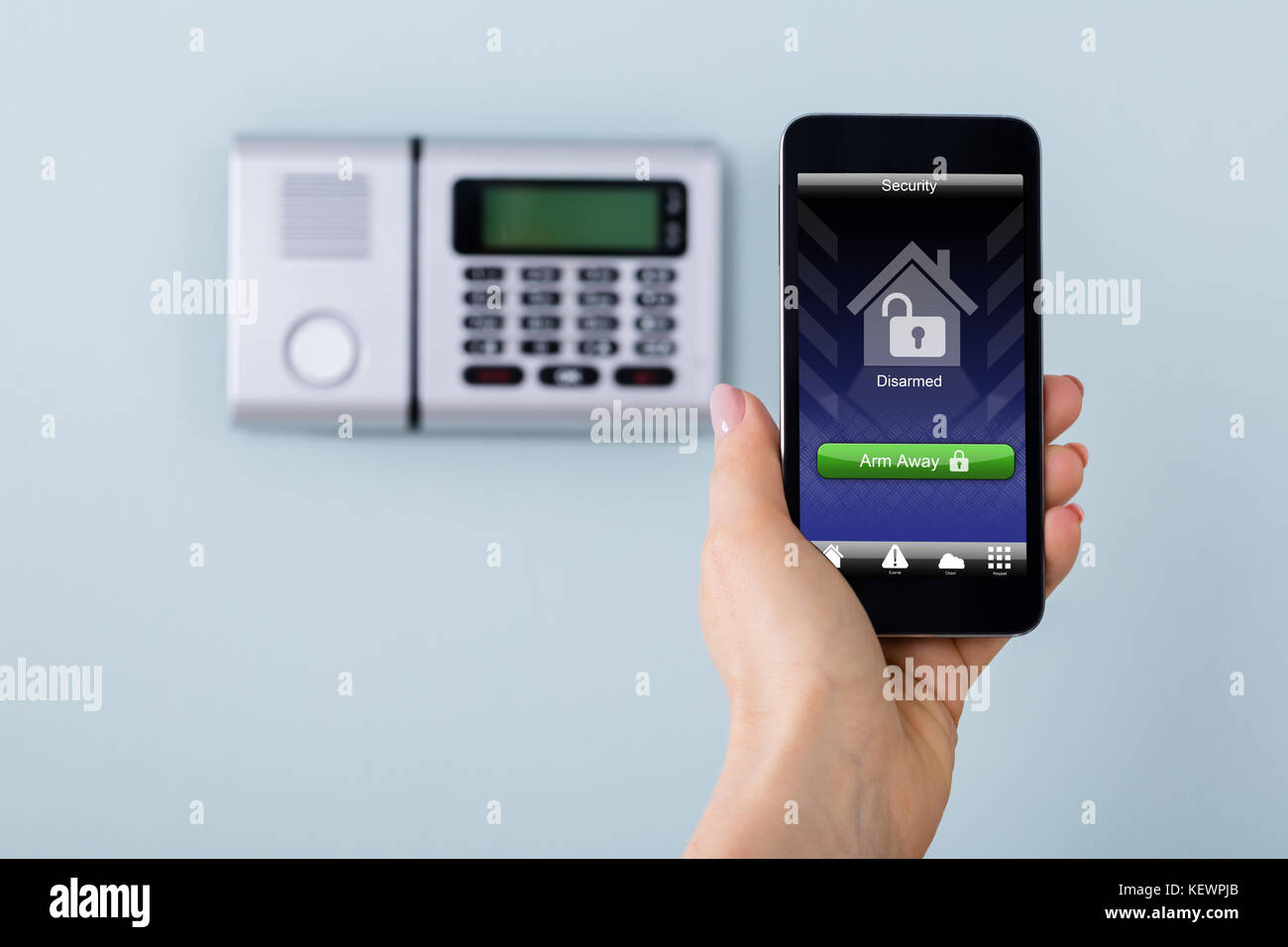 Security Alarm Keypad With Person Arming The System With Remote