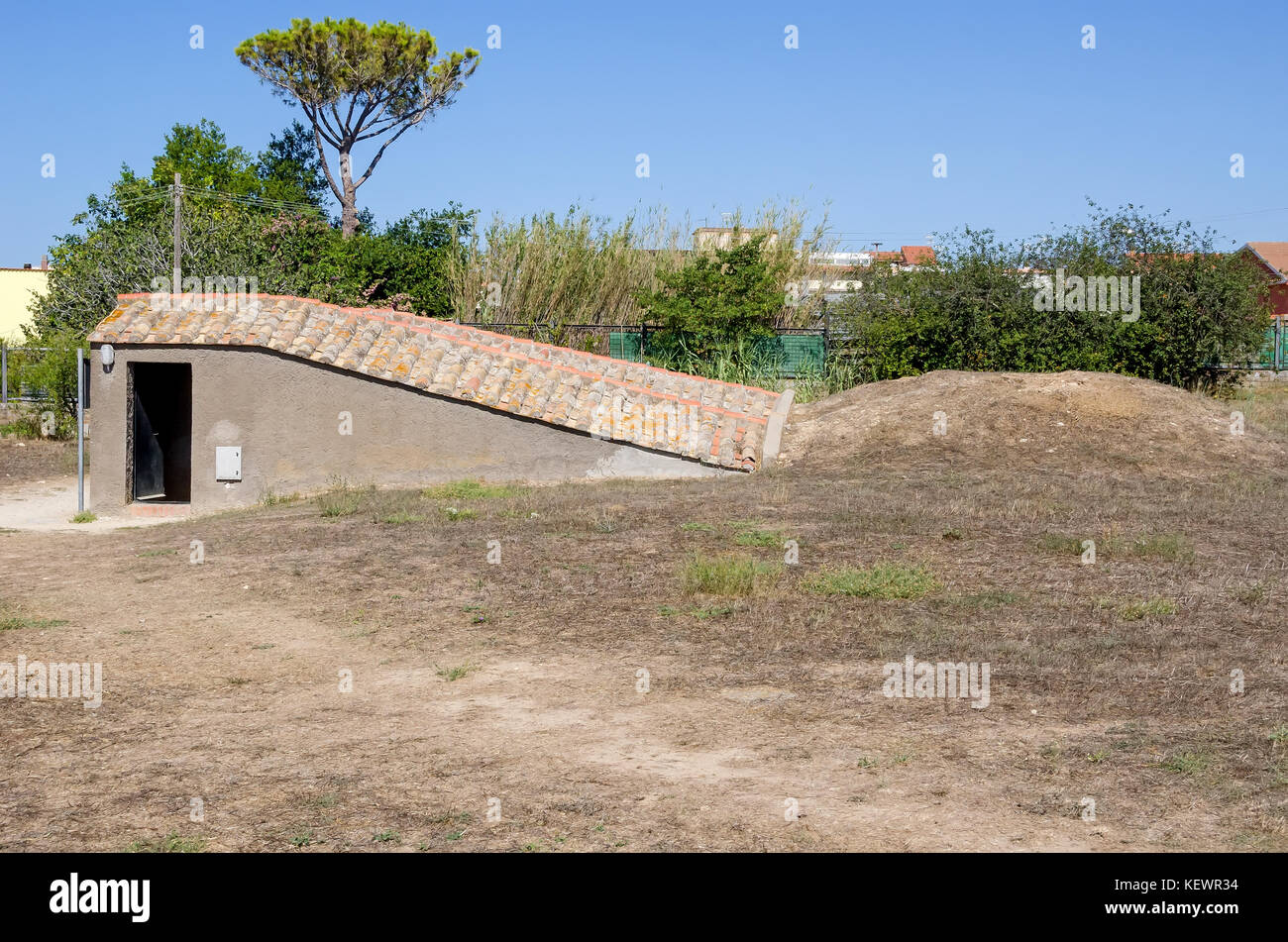 Burial mound and protected tomb stairway to painted Etruscan tomb at Monterozzi necropolis, Tarquinia,Viterbo, Lazio, Italy. Stock Photo