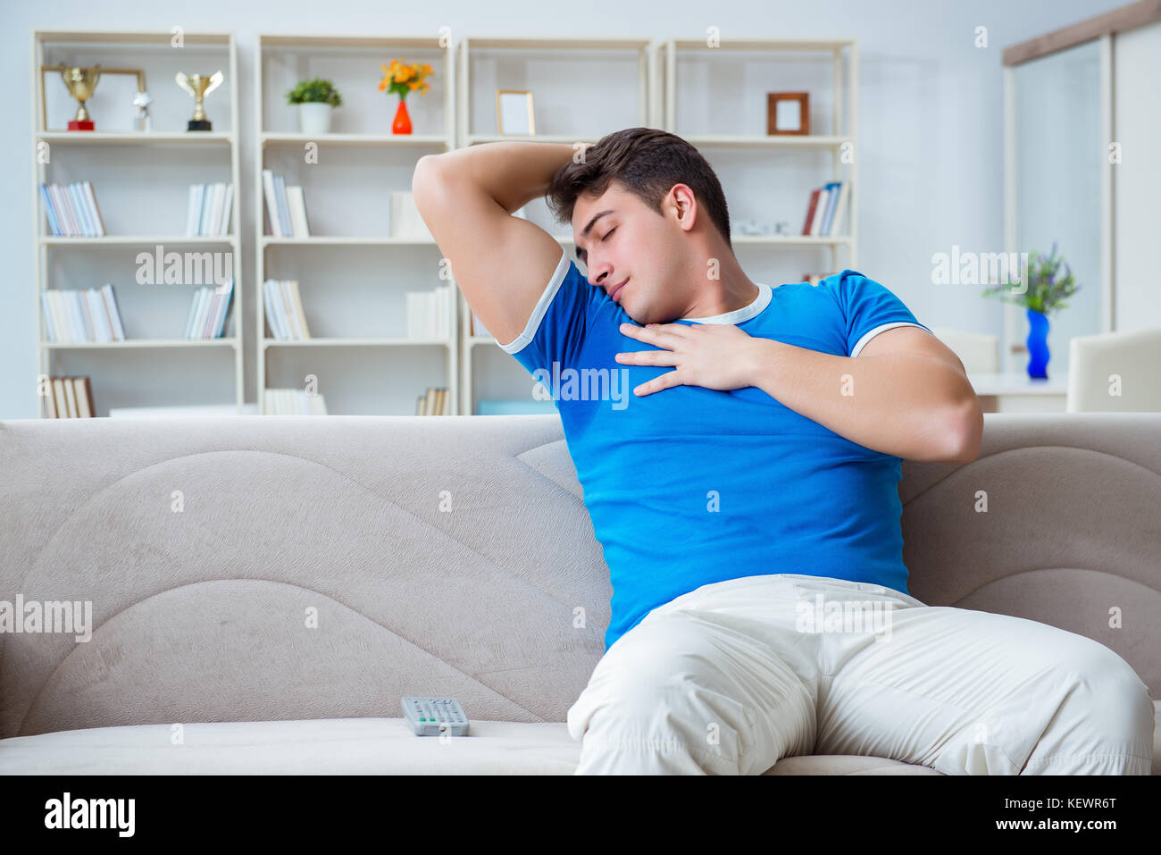 Man sweating excessively smelling bad at home Stock Photo Alamy