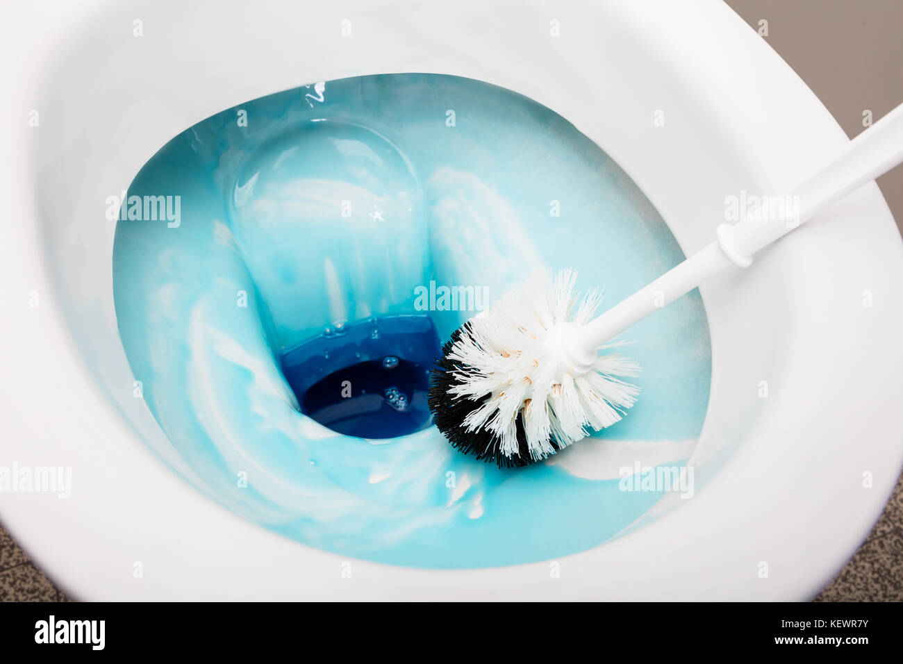 High Angle View Of A Person Cleans A Bathroom Toilet With A Scrub Brush Stock Photo