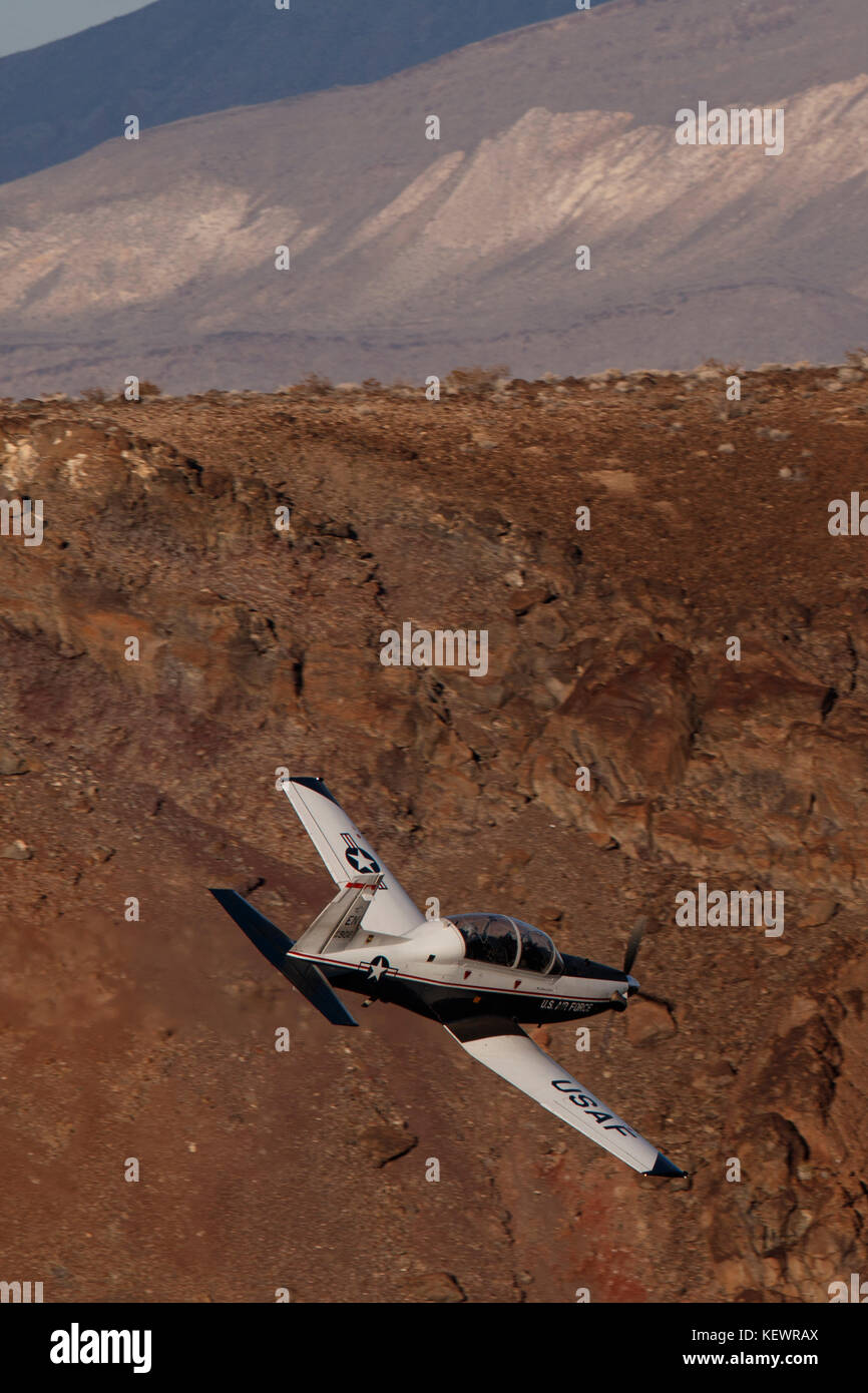 Beechcraft T-6 Texan II from United States Air Force 80th Flying Training Wing, Sheppard Air Force Base, Texas, flies low level through the Jedi Transition, Star Wars Canyon, Death Valley National Park, California, United States of America Stock Photo