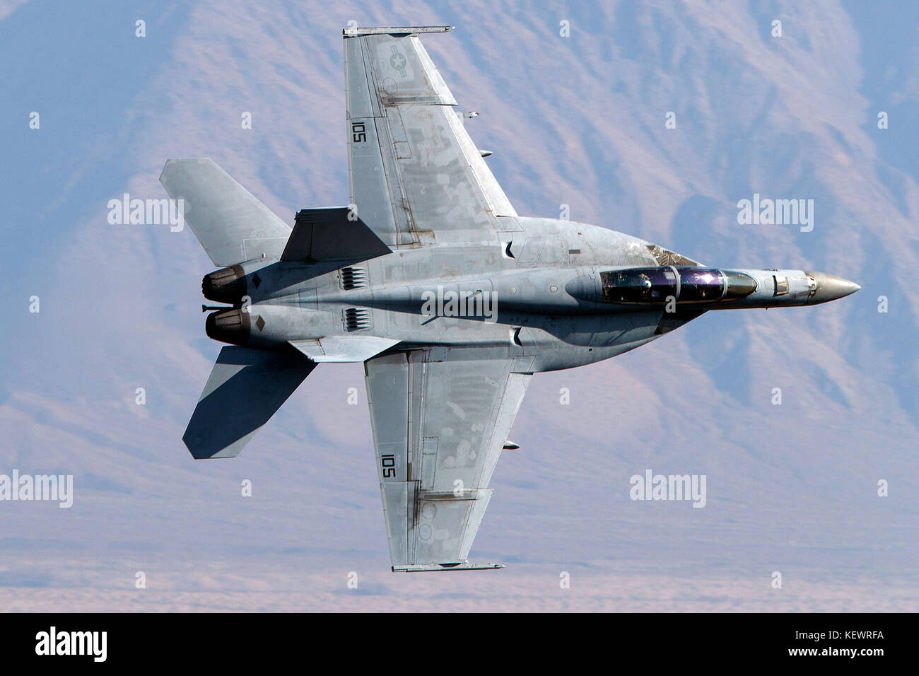 United States Navy Boeing F/A-18F Super Hornet (NE 105) from the VFA-2 Bounty Hunters squadron, Naval Air Station Lemoore, flies low level on the Jedi Transition through Star Wars Canyon / Rainbow Canyon, Death Valley National Park, Panamint Springs, California, United States of America Stock Photo