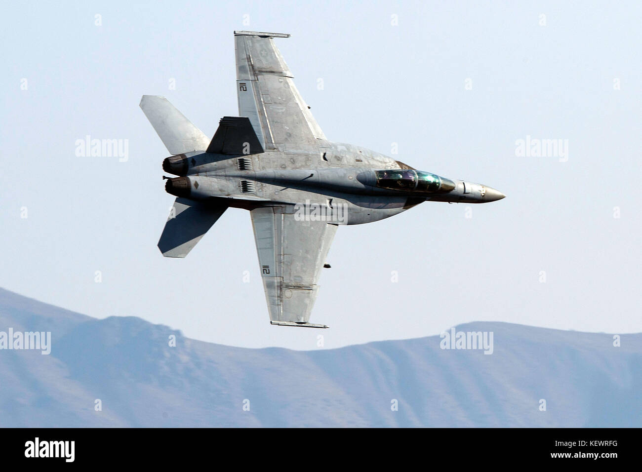 United States Navy Boeing F/A-18F Super Hornet (NE 112) from the VFA-2 Bounty Hunters squadron, Naval Air Station Lemoore, flies low level on the Jedi Transition through Star Wars Canyon / Rainbow Canyon, Death Valley National Park, Panamint Springs, California, United States of America Stock Photo