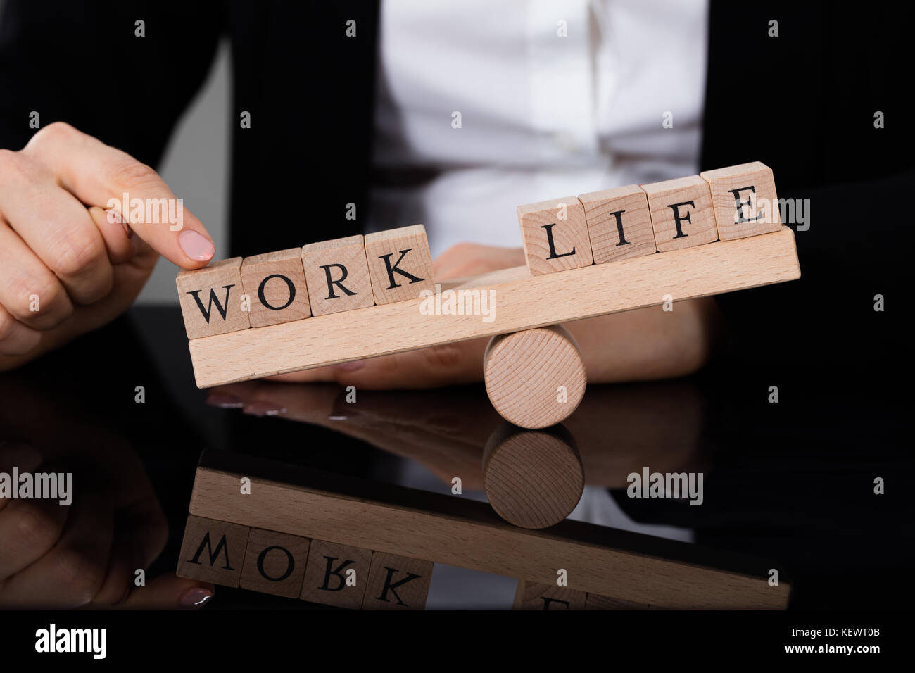 Close-up Of A Person Showing Imbalance Between Life And Work On Seesaw ...