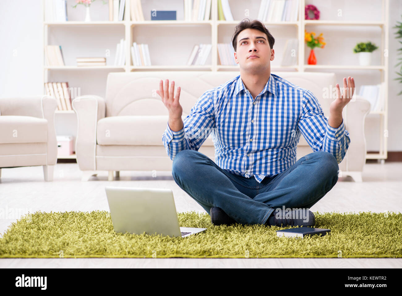 Young handsome man sitting on floor at home Stock Photo - Alamy