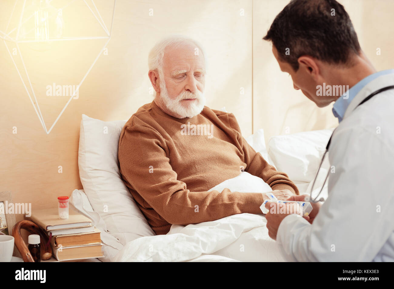 Sad grey-haired male person listening to his doc Stock Photo - Alamy