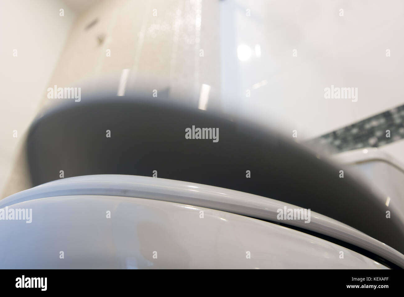 The toilet bowel lid moving down. The toilet bowl cover fall down. Cover of toilet bowl