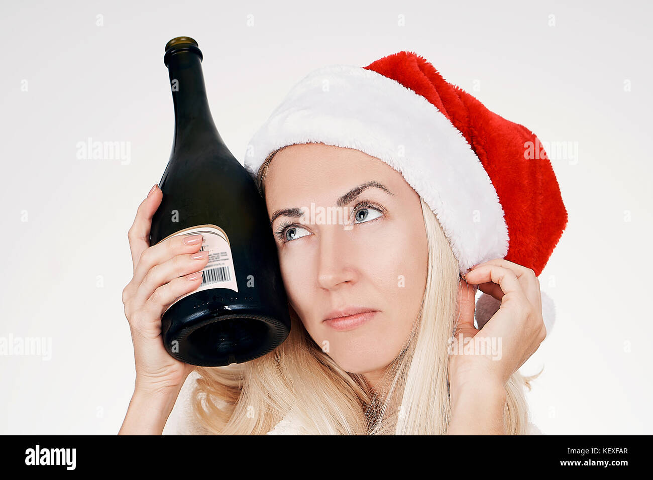 Girl With A Bad Appearance, In A Bra And Mask For Sleeping, Holds A Bottle  Of Alcohol And Looks At It. Stock Photo, Picture and Royalty Free Image.  Image 92392163.