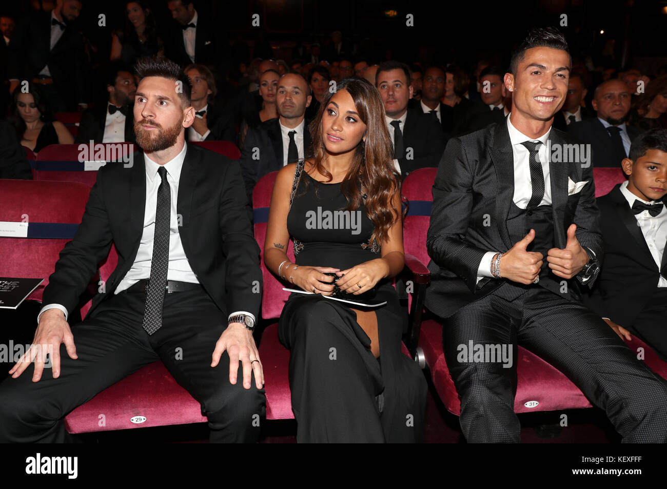 (left to right) Lionel Messi, Antonella Roccuzzo and Cristiano Ronaldo during the Best FIFA Football Awards 2017 at the Palladium Theatre, London. Stock Photo