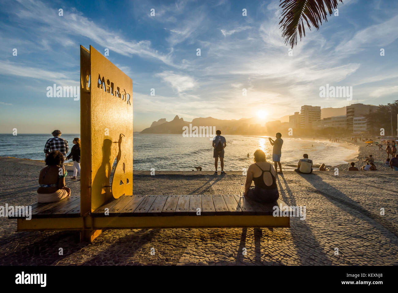 Photograph of sunset at Arpoador Beach with people, Rio de Janeiro, Brazil Stock Photo