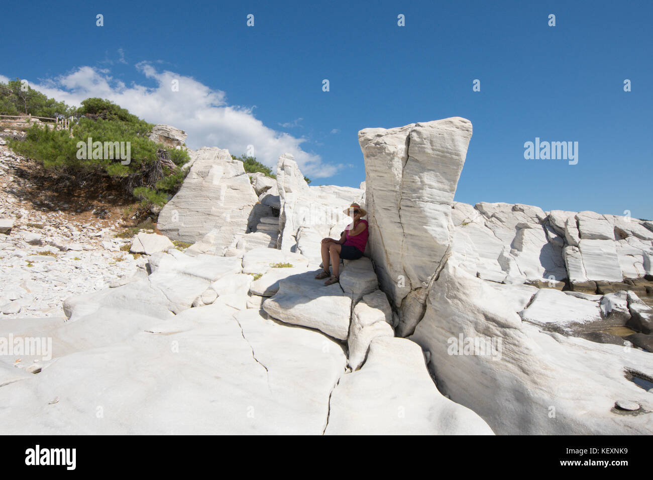 woman visitor in the ancient marble quarry on the promontory at Aliki, Thassos, Greece, Greek island, September, Stock Photo