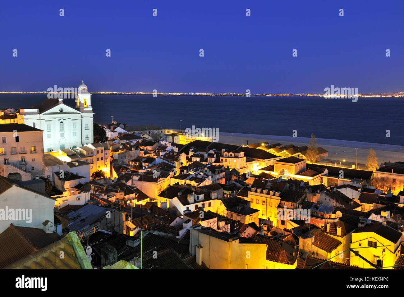 Alfama district and the Tagus river in the evening. Portas do Sol belvedere. Lisbon, Portugal Stock Photo
