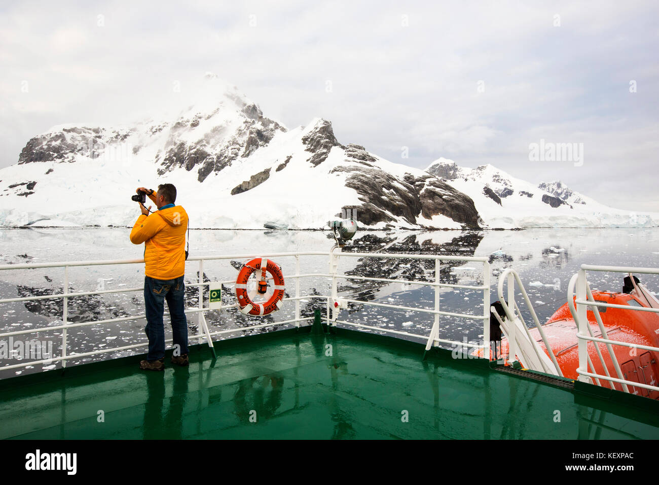 A passenger on the deck of the Akademik Sergey Vavilov, an ice strengthened ship on an expedition cruise to Antarctica, off the Antarctic peninsula. Stock Photo