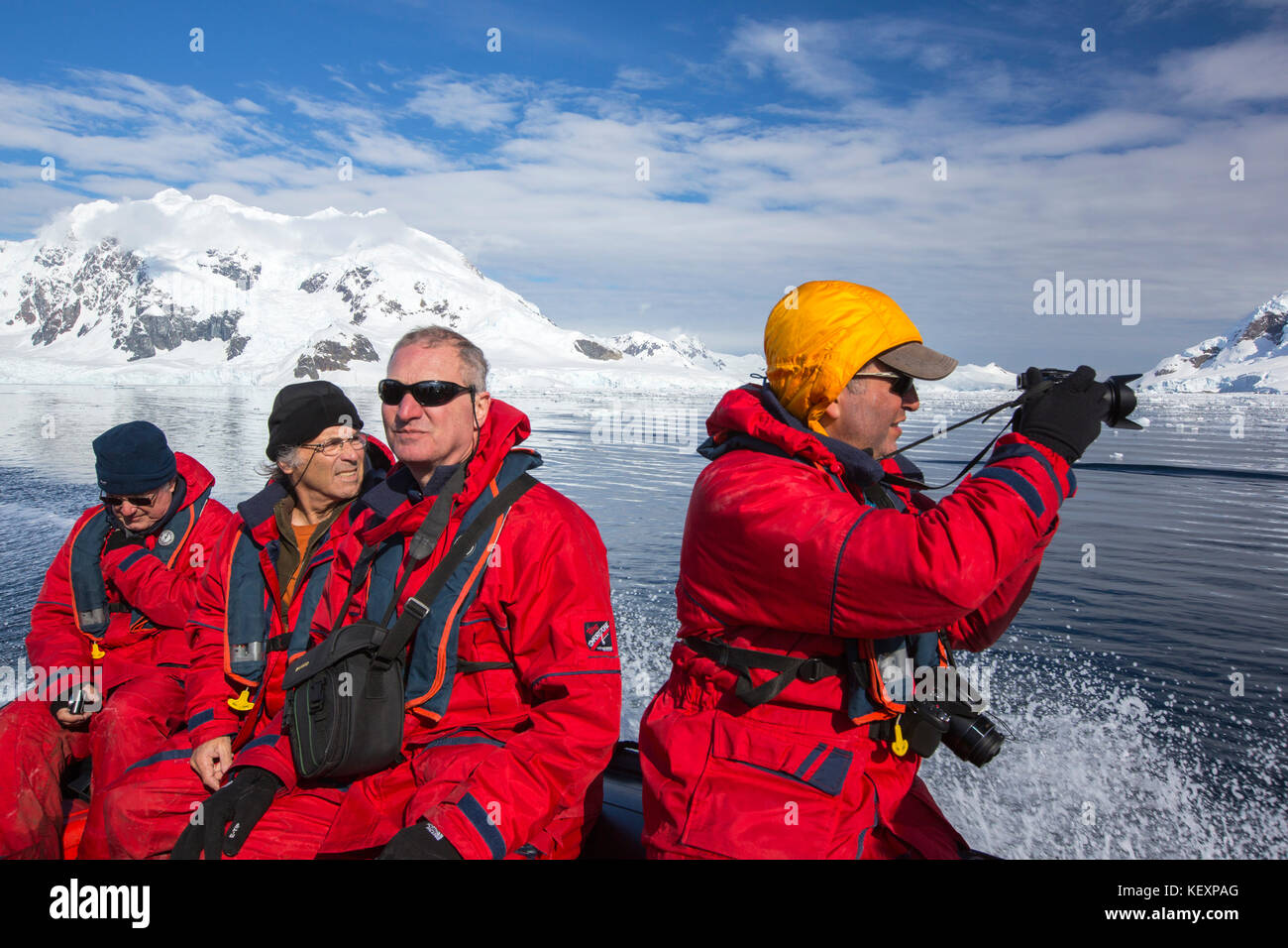Members of an expedition cruise to Antarctica in a Zodiak in Paradise Bay beneath Mount Walker on the Antarctic peninsula. The Antarctic peninsula is one of the most rapidly warming areas on the planet. Stock Photo