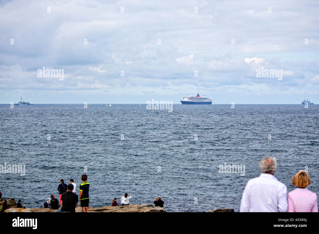 the Queen Mary 2 passing Groix Island, on her way to Saint Nazaire for the start of the centennial Transat The Bridge 2017, a historic transatlantic race between her and a fleet of giant trimarans. Stock Photo