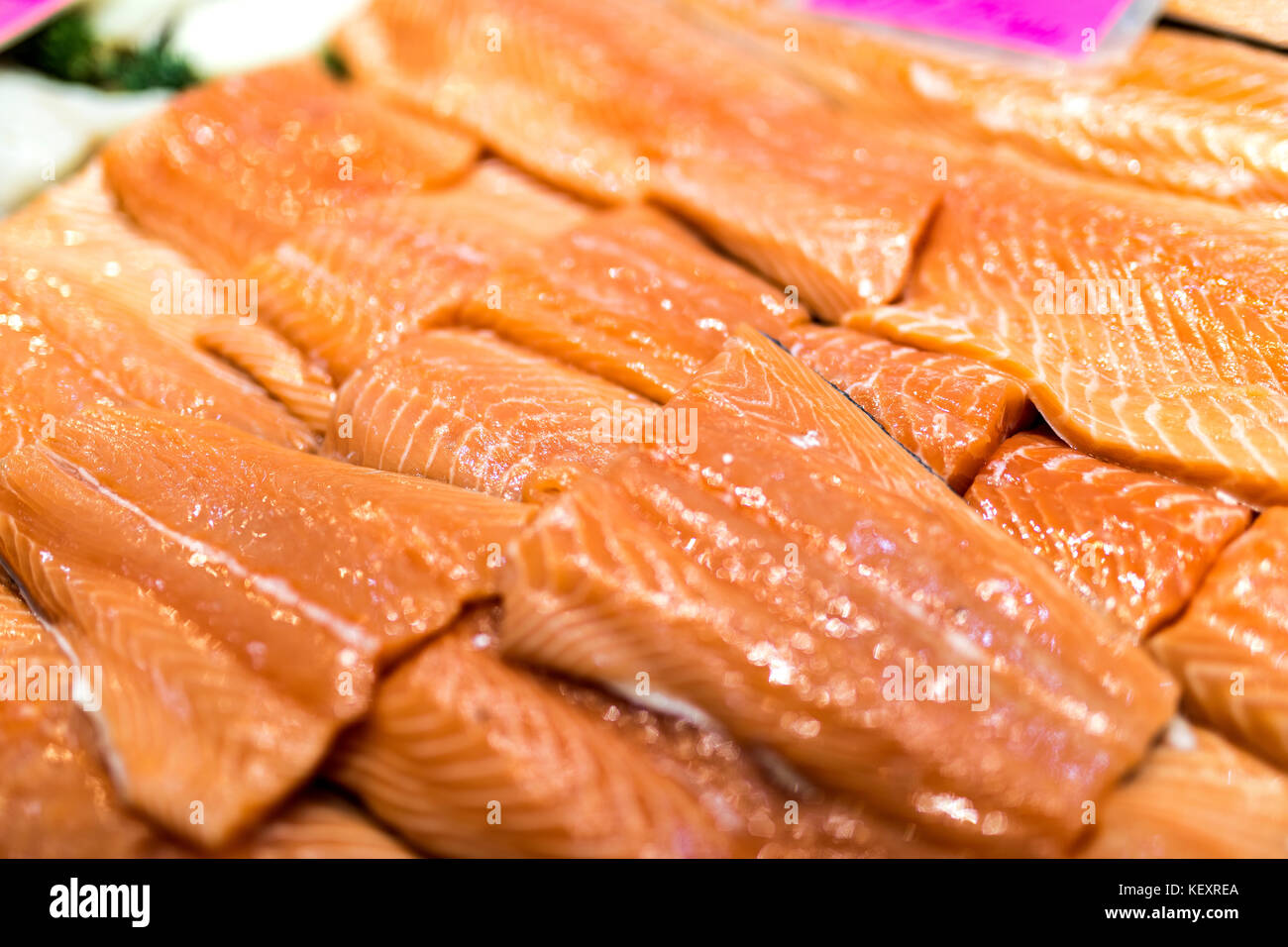 Close up of salmon fillets spread over ice on a fish monger’s market stall in Yorkshire, England, UK Stock Photo